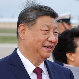 Donald Trump and Chinese President Xi Jinping speak as Xi arrives ahead of a state visit at Joint Base Andrews, Maryland.
