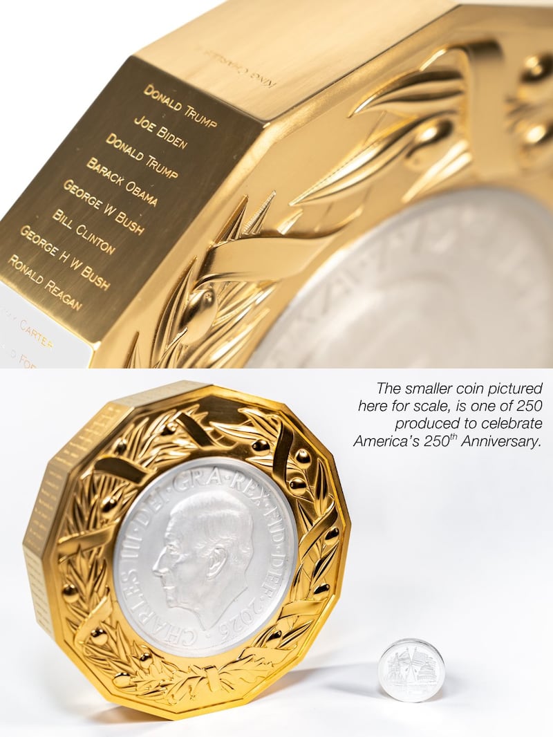 A close-up of the gold-framed coin