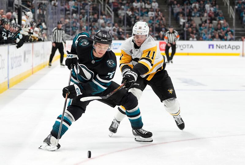SAN JOSE, CALIFORNIA - OCTOBER 18: Filip Hallander #11 of the Pittsburgh Penguins and William Eklund #72 of the San Jose Sharks battles for control of the puck in the third period at SAP Center on October 18, 2025 in San Jose, California. (Photo by Thearon W. Henderson/Getty Images)