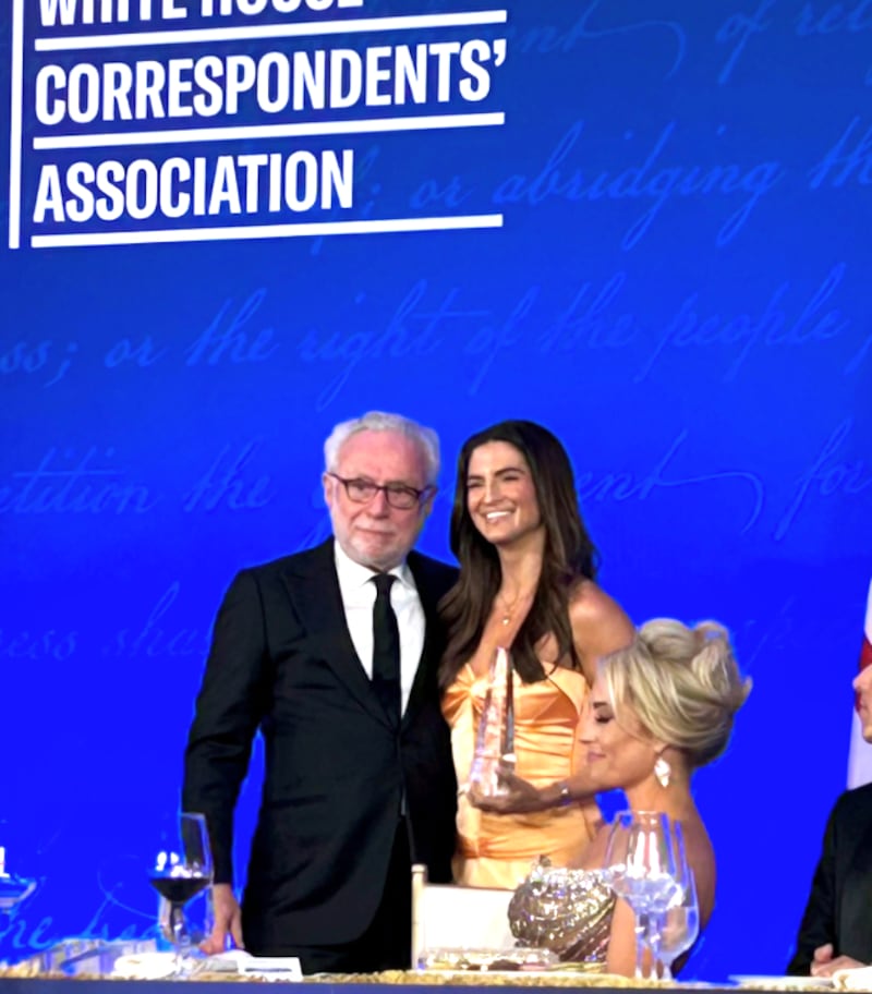 Kaitlan Collins accepts an award from her colleague and mentor, Wolf Blitzer.