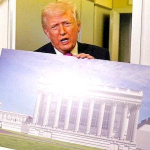 President Donald Trump talks to members of the media while holding up renderings of the planned White House ballroom, aboard Air Force One en route to Joint Base Andrews, Maryland, U.S., March 29, 2026.