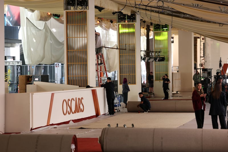 Staff members work on the day of the red carpet rollout for the 98th Academy Awards