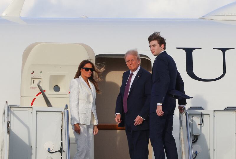 US President-elect Donald Trump, his wife Melania Trump and their son Barron board a US government aircraft at Palm Beach International Airport in West Palm Beach, Florida, on January 18, 2025.