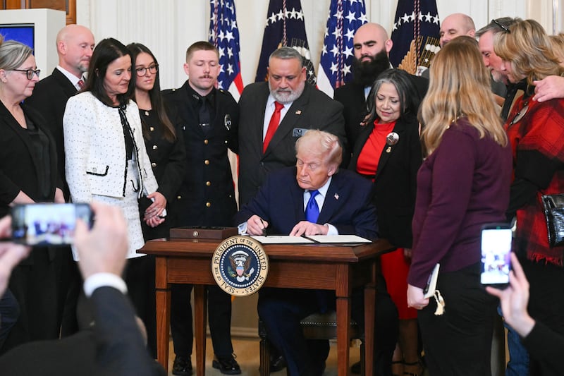 President Donald Trump signs a National Angel Family Day Proclamation during the Angel Families Remembrance Ceremony in the East Room of the White House on February 23, 2026.