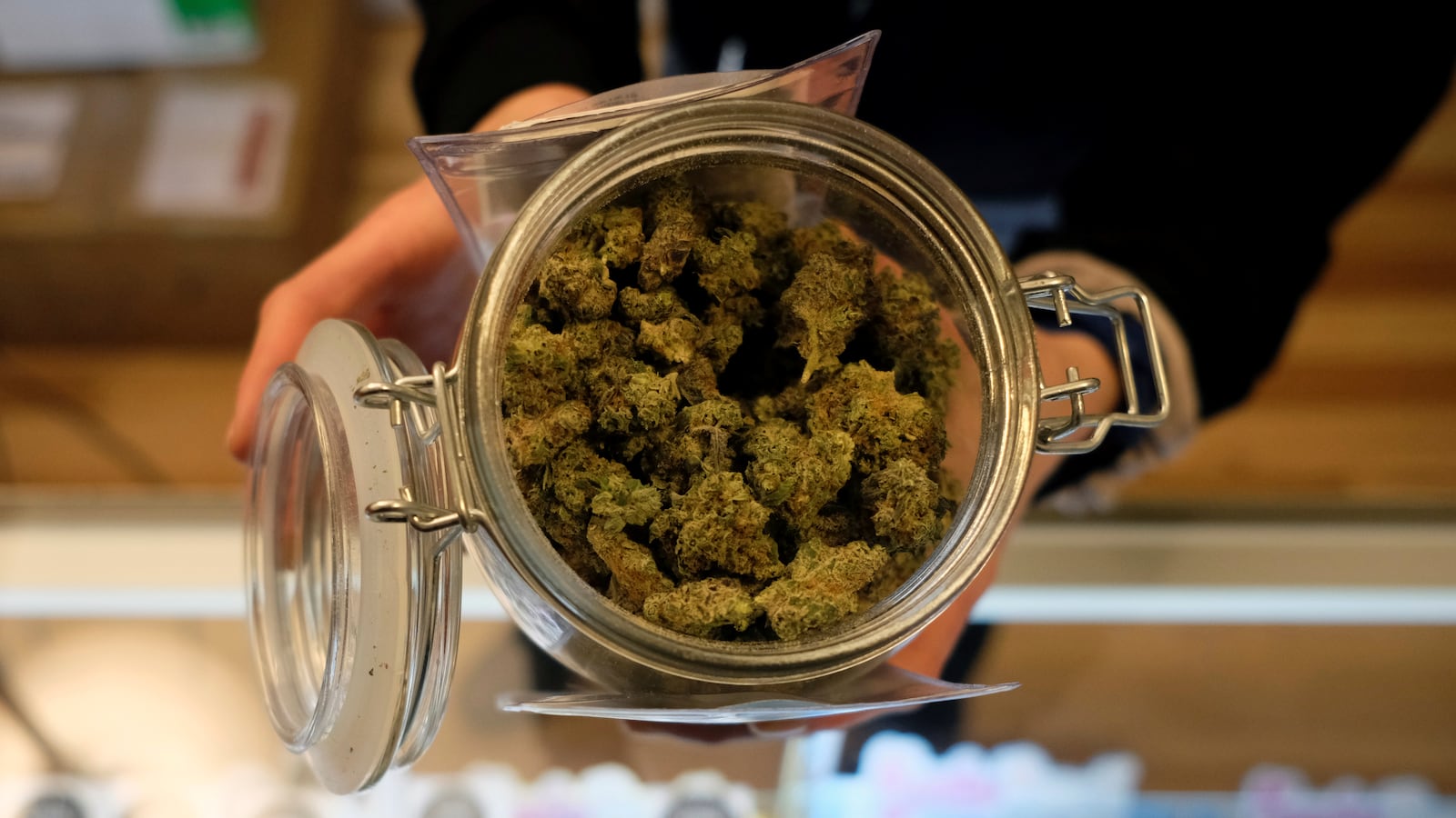 An employee holds a jar of marijuana on sale at the Greenstone Provisions in Ann Arbor, Michigan.