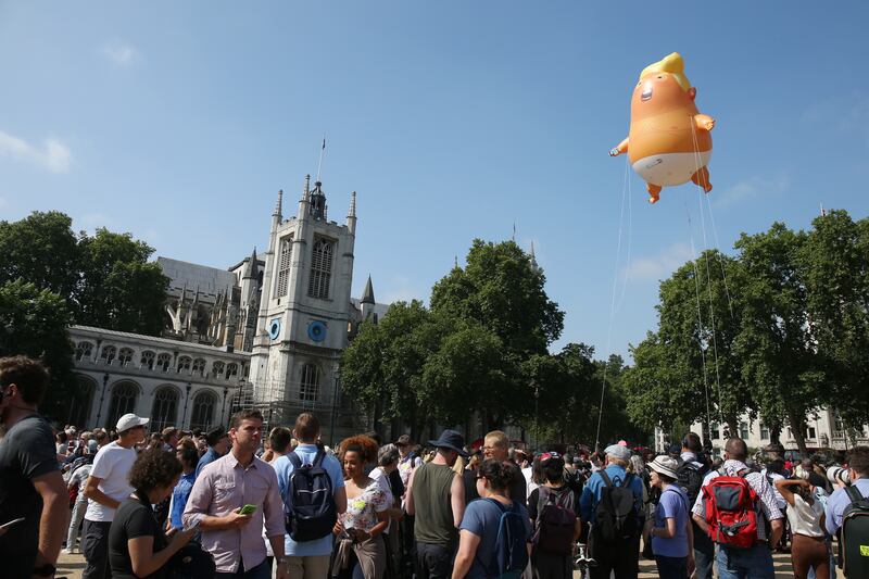 LONDON, UNITED KINGDOM - JULY 13: The 'Trump Baby' blimp, a six meter-high helium-filled effigy of U.S. President Donald Trump, flies over Parliament Square in London, U.K. on Friday, July 13, 2018. Trump dealt a double blow to U.K. Prime Minister Theresa May, saying her plans for a soft Brexit would likely end hopes of a trade deal with the U.S. and that Boris Johnson, who quit her cabinet this week, would be a 'great' leader (Photo by Neil Mockford/Getty Images)