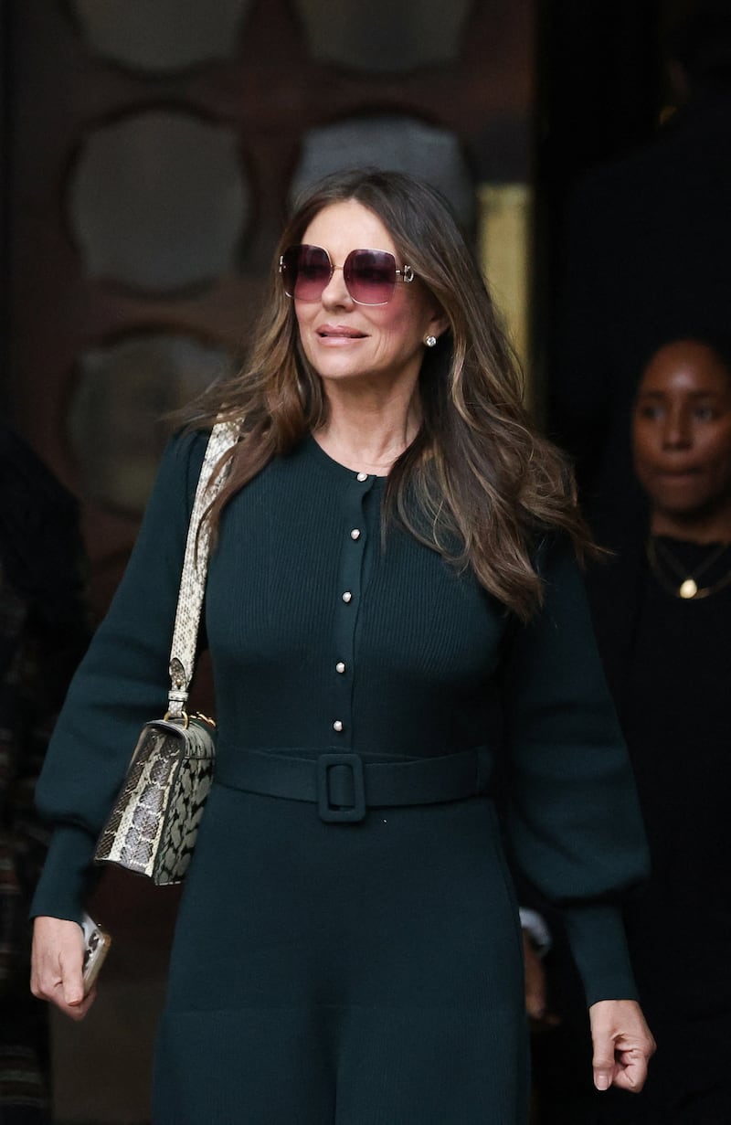 Actor Liz Hurley walks outside the High Court, during the first week of an expected nine-week trial lawsuit against Associated Newspapers