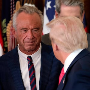 WASHINGTON, DC - NOVEMBER 13: President Donald Trump, shakes hands with Health and Human Services Secretary Robert F. Kennedy Jr. alongside Secretary of Housing and Urban Development Scott Turner (L) after Trump signed the "Fostering the Future" executive order the East Room of the White House on November 13, 2025 in Washington, DC. The executive order, championed by first lady Melania Trump, works to expand opportunities for education, career development, housing and other resources for youth transitioning from foster care to adulthood.  (Photo by Heather Diehl/Getty Images)