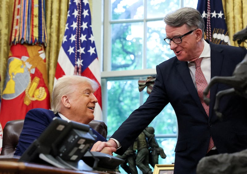 U.S. President Donald Trump shakes hands with Britain's ambassador to the United States, Peter Mandelson, after announcing a trade deal with the U.K., in the Oval Office at the White House in Washington, D.C., U.S., May 8, 2025. REUTERS/Leah Millis