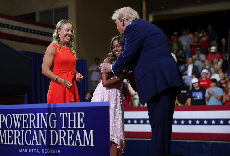 President Donald Trump greets a family on stage as they speak about Trump Accounts during an event at Wheeler High School on July 22, 2026 in Marietta, Georgia.