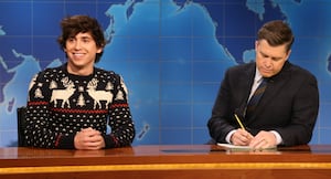 SATURDAY NIGHT LIVE -- Episode 1892 -- Pictured: (l-r) Marcello Hernández and anchor Colin Jost during Weekend Update on Saturday, December 13, 2025 -- (Photo by: Will Heath/NBC via Getty Images)