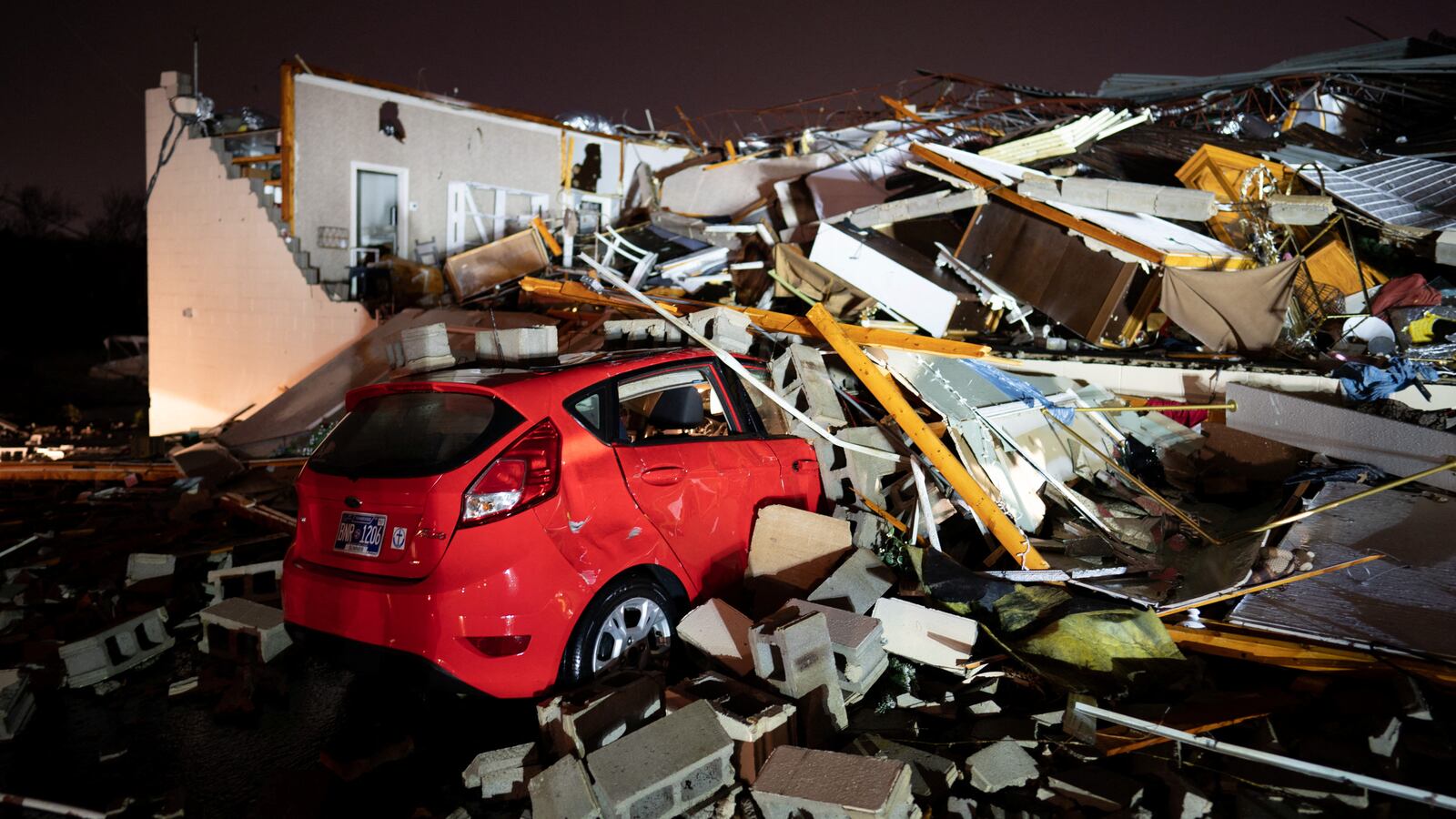 A car is buried under rubble on Main Street after a tornado hit Hendersonville, Tennessee, U.S. December 9, 2023.