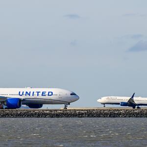 SAN FRANCISCO, CALIFORNIA - JULY 24: A Delta Airlines plane lands as a United Airlines plane is taxiing to takeoff at San Francisco International Airport (SFO) in San Francisco, California, United States on July 24, 2025.
