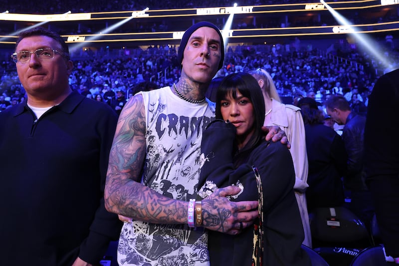 Travis Barker and his wife Kourtney Kardashian attend the UFC 324 event in January 2026.