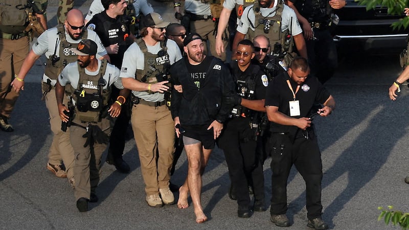 MMA fighter Sean Strickland is escorted out of the UFC Freedom 250 Fan Fest on The Ellipse by U.S. Secret Service and other law enforcement ahead of the UFC Freedom 250 fight on the South Lawn of the White House, in Washington, D.C., U.S., June 14, 2026.      Kevin Dietsch/Pool via REUTERS     TPX IMAGES OF THE DAY