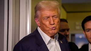 U.S. President Donald Trump, accompanied by U.S. Secretary of State Marco Rubio (R), takes a question from a reporter aboard Air Force One on October 27, 2025, in flight.