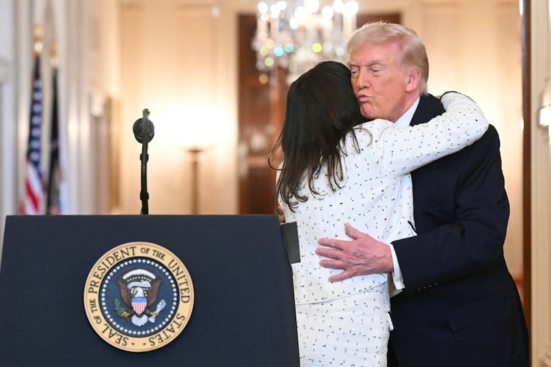 US President Donald Trump embraces Allyson Phillips, the mother of Laken Riley, a 22-year-old nursing student who was murdered in 2024 by a Venezuelan man who entered the US illegally, during the Angel Families Remembrance Ceremony in the East Room of the White House in Washington, DC, on February 23, 2026. Laken Riley, a 22-year-old University of Georgia nursing student who was murdered in 2024 by an undocumented immigrant. (Photo by SAUL LOEB / AFP via Getty Images)