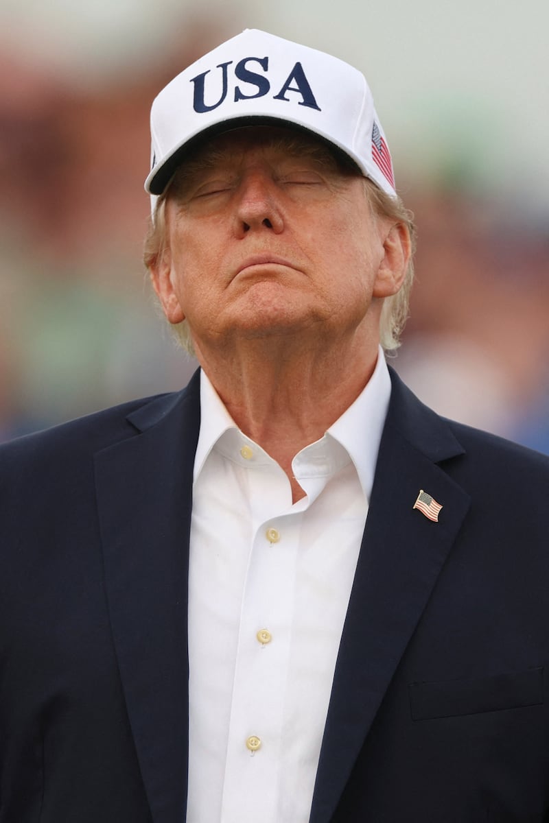 U.S. President Donald Trump reacts at the Amgen Irish Open 2026, at Trump International Golf Links in Doonbeg, County Clare, Ireland, September 13, 2026. REUTERS/Cathal McNaughton