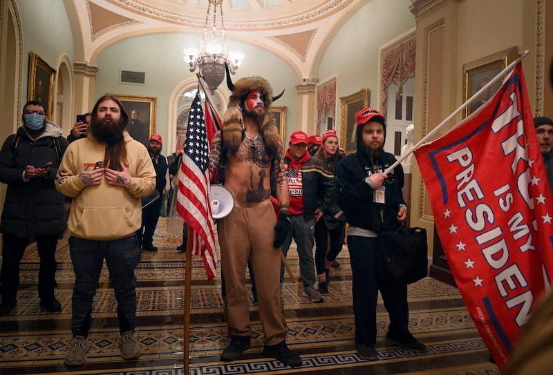 Supporters of US President Donald Trump, including member of the QAnon conspiracy group Jake Angeli, aka Yellowstone Wolf (C), enter the US Capitol on January 6, 2021, in Washington, DC. Demonstrators breeched security and entered the Capitol as Congress debated the a 2020 presidential election Electoral Vote Certification.
