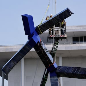 Crews work to remove the sculpture titled "Blue" by artist Joel Shapiro from the grounds of The Kennedy Center for the Performing Arts, after it was targeted for removal by the Trump administration, in Washington, D.C., September, 2, 2026. REUTERS/Jonathan Ernst