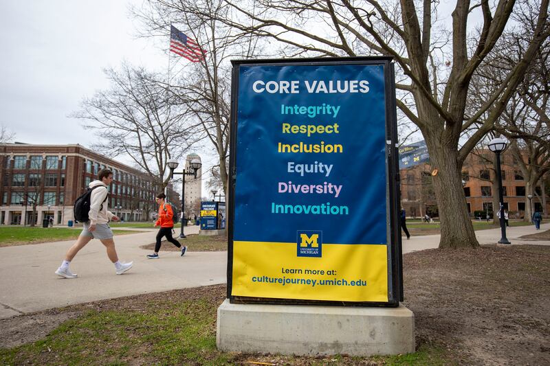 ANN ARBOR, MICHIGAN - APRIL 3: University of Michigan students walk on the UM campus next to signage displaying the University's "Core Values" on April 3, 2025 in Ann Arbor, Michigan. Last week, the University stated it was closing its Office of Diversity, Equity and Inclusion, Office of Healthy Equity and Inclusion, and its DEI 2.0 Strategic Plan, all in response to President Donald Trump's Executive Orders concerning DEI. (Photo by Bill Pugliano/Getty Images)