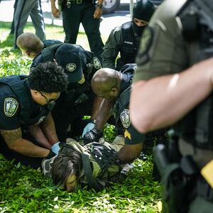 Police officers detain a demonstrator during a pro-Palestinian protest against the war in Gaza at Emory University on April 25, 2024, in Atlanta, Georgia.