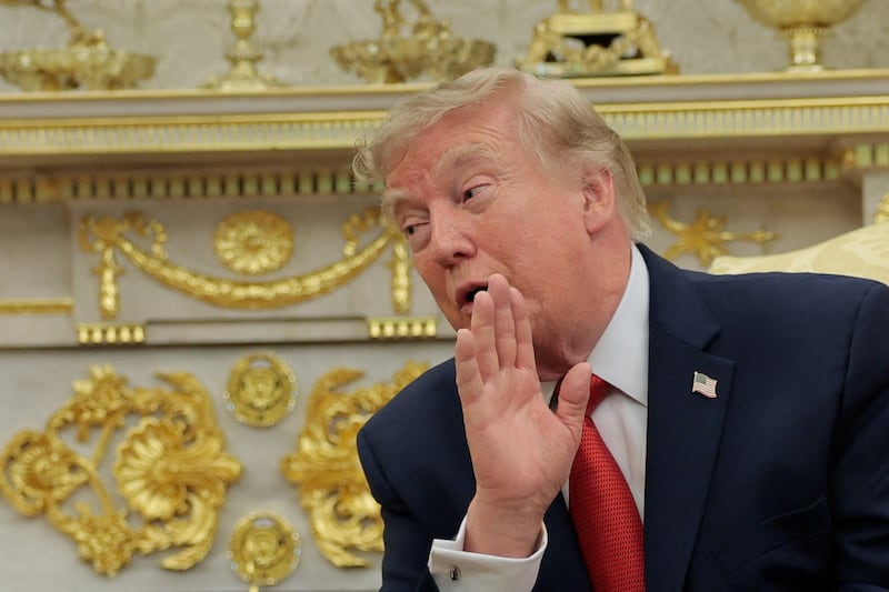 U.S. President Donald Trump speaks as he hosts 16-year-old lifeguard Ryder Williams, who saved a child off the coast of Santa Cruz, California, last month, Nathaniel Rai, the child saved by Williams, and Nathaniel's family members in the Oval Office at the White House in Washington, D.C., U.S., August 17, 2026.