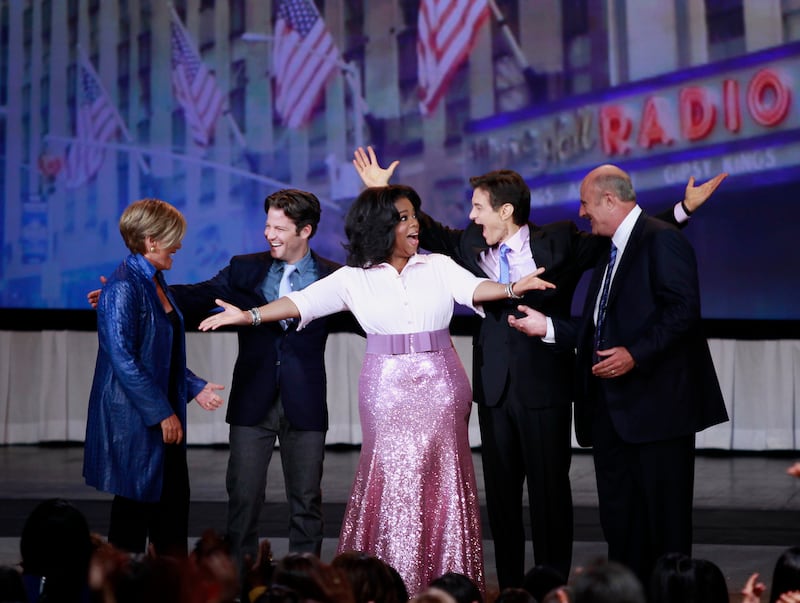 U.S. talk show host Oprah Winfrey (C) introduces her guests (from L to R) Suze Orman, Nate Berkus, Dr. Oz, and Dr. Phil during a special live show at Radio City Music Hall in celebration of O Magazine's 10th anniversary in New York City, May 7, 2010.