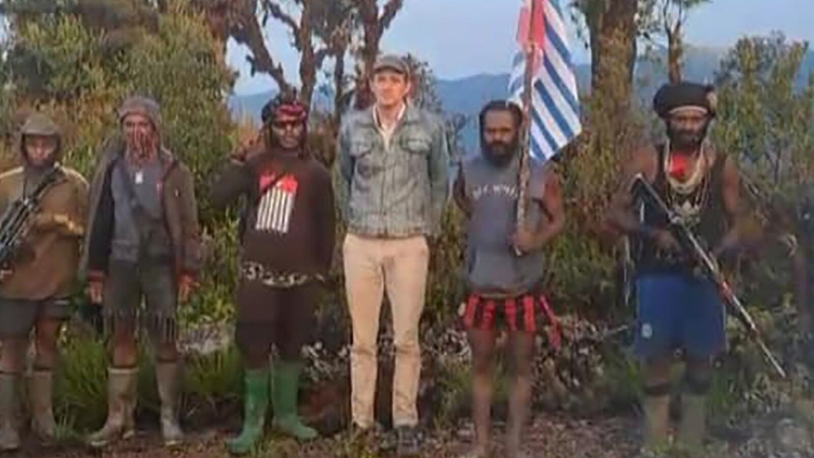 New Zealand pilot Philip Mehrtens appears alongside captors in Papua, Indonesia.
