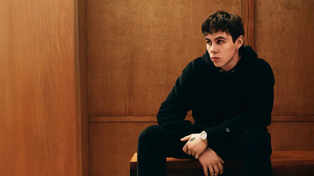 Man sitting wearing Reverse Wear hoodie and joggers from Champion