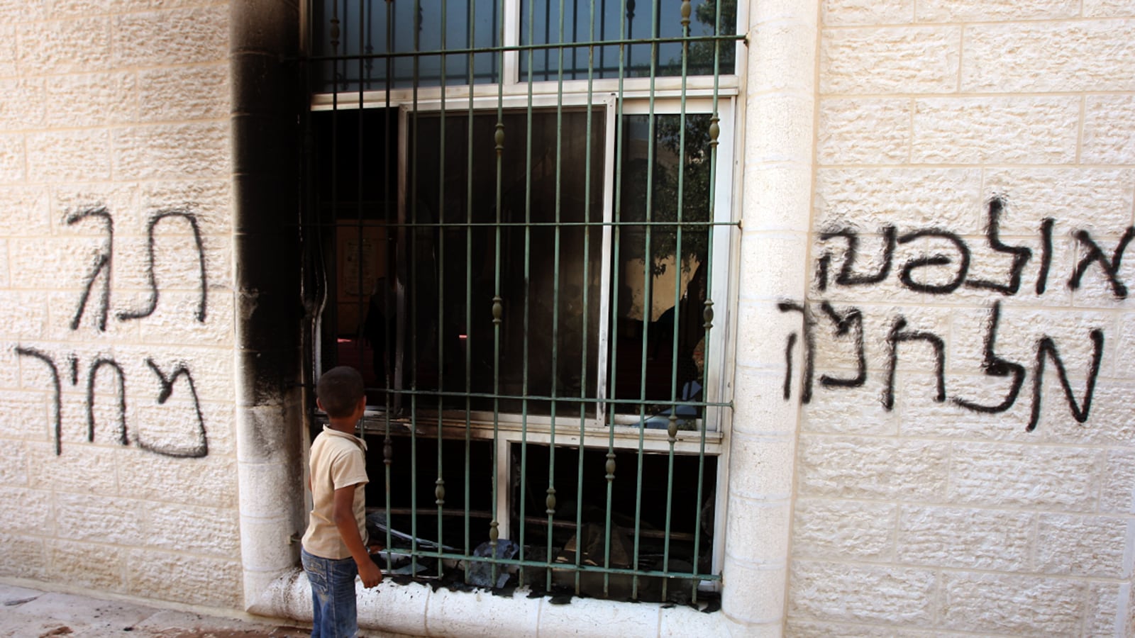 articles/2012/06/29/fearing-public-backlash-israeli-settlers-speak-out-against-their-own/west-bank-mosque-burned-ephron_yfmy7y