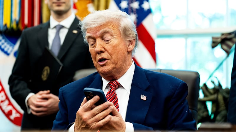 President Donald Trump, pictured silencing his cellphone in the Oval Office on May 23, has long been known for picking up the phone and making calls to reporters to get his side of a story out.