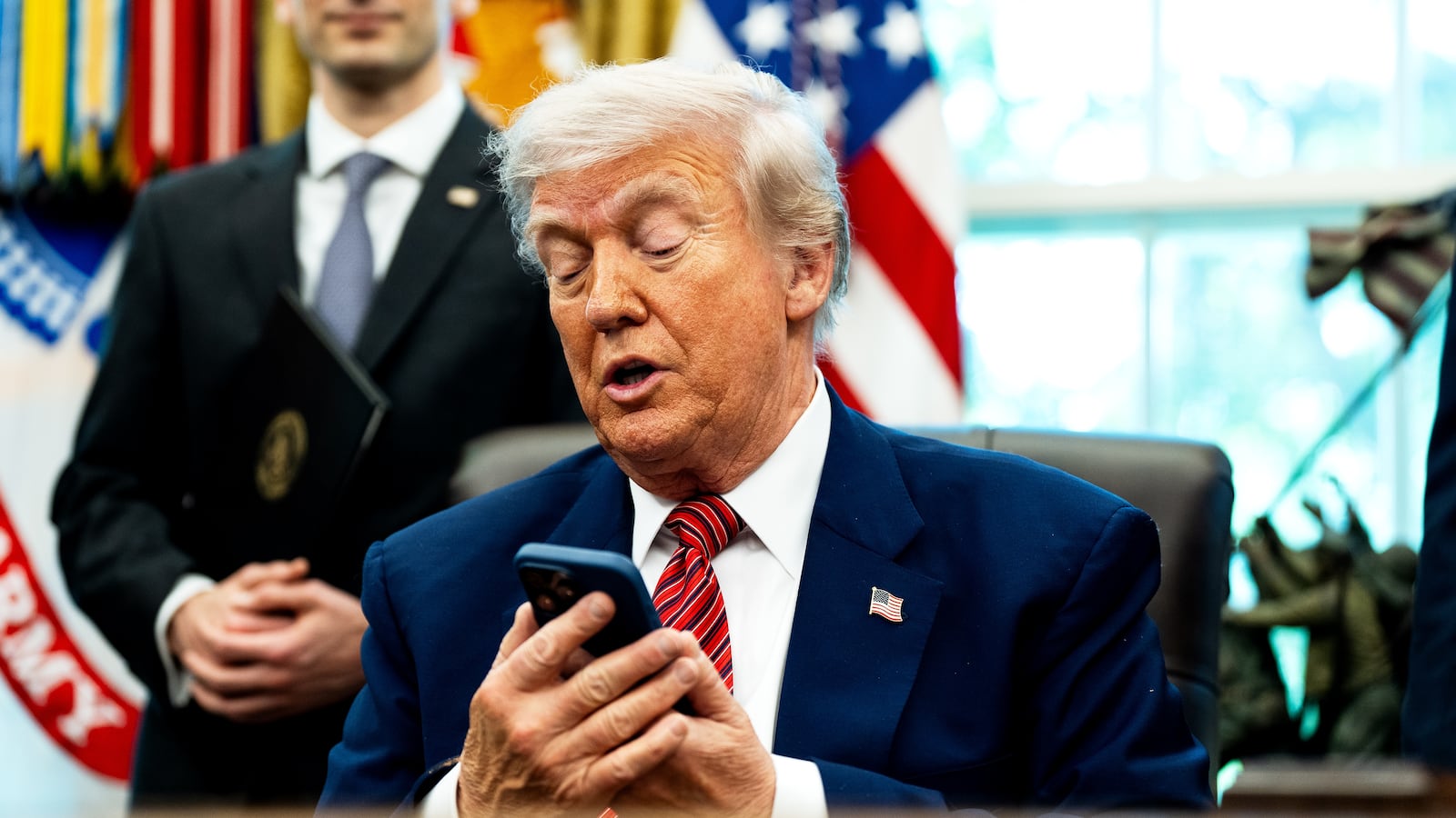 President Donald Trump, pictured silencing his cellphone in the Oval Office on May 23, has long been known for picking up the phone and making calls to reporters to get his side of a story out.