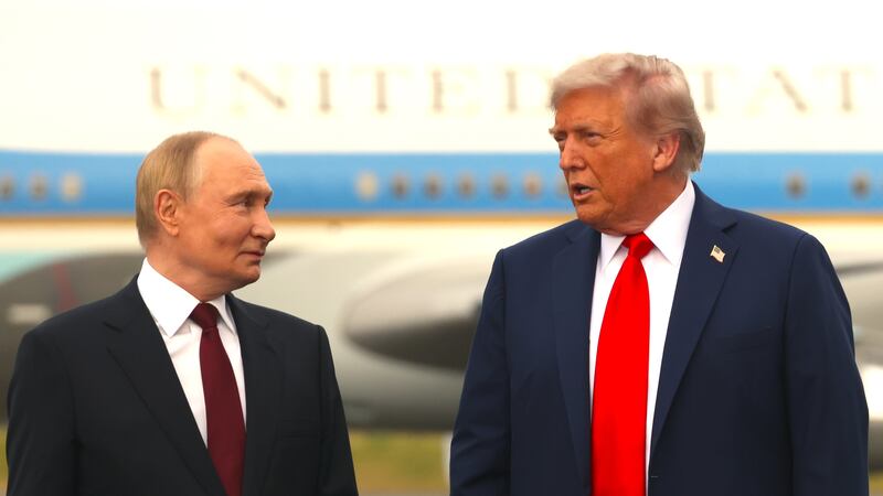 Russian President Putin (L) listens to U.S. President Donald Trump (R) during the welcoming ceremony prior to the meeting on war in Ukraine