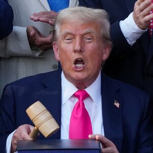 U.S. President Donald Trump reacts, while he holds a gavel, on the day he signs the sweeping spending and tax legislation, known as the "One Big Beautiful Bill Act," at the White House in Washington, D.C., U.S., July 4, 2025. REUTERS/Ken Cedeno