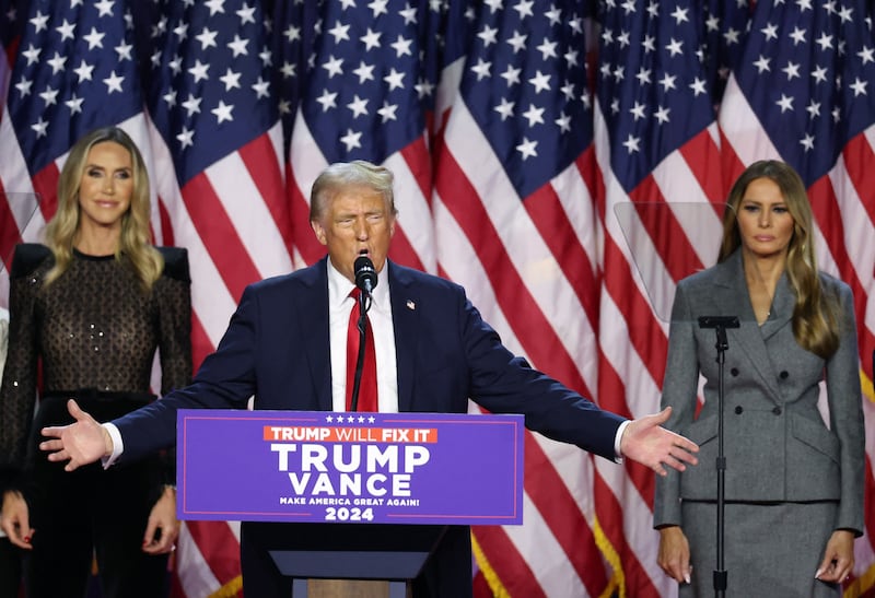 Republican presidential nominee and former U.S. President Donald Trump is flanked by Melania Trump and Lara Trump as he addresses supporters, during the 2024 U.S. Presidential Election, in Palm Beach County Convention Center, in West Palm Beach, Florida, U.S., November 6, 2024. REUTERS/Brendan Mcdermid