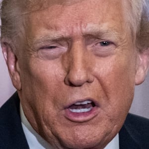 President Donald Trump speaks to the media aboard Air Force One