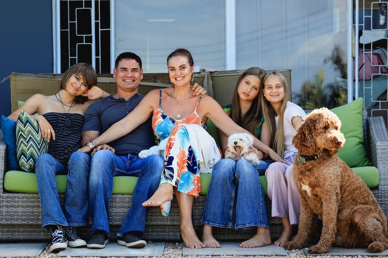 Naomi and Danny Saphire pose with their children and dogs at their new home in Plettenberg Bay after returning from the U.S., in the Western Cape, South Africa, March 7, 2026. REUTERS/Esa Alexander
