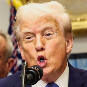 U.S. President Donald Trump, in front of U.S. Secretary of Health and Human Services Robert F. Kennedy Jr., delivers remarks at the White House, in Washington, D.C., U.S., September 22, 2025. REUTERS/Kevin Lamarque