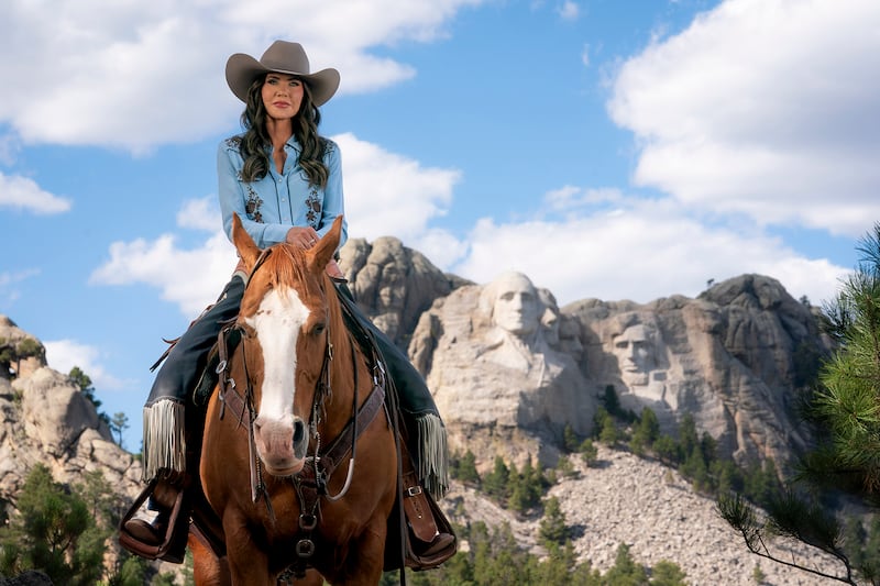 Secretary of Homeland Security Kristi Noem rides a horse while filming an ad at Mount Rushmore National Memorial in South Dakota, Oct. 2, 2025.