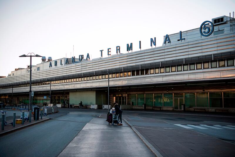 A passanger walks outside the international terminal of Arlanda airport, north of Stockholm, on March 16, 2020, where air traffic slowed down due to the spread of the novel coronavirus COVID-19. (Photo by Jonathan NACKSTRAND / AFP) (Photo by JONATHAN NACKSTRAND/AFP via Getty Images)