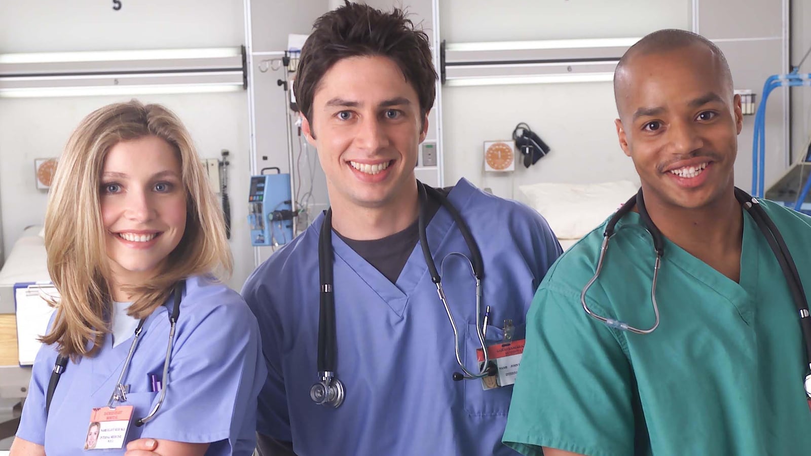 Actors Sarah Chalke, Zach Braff, and Donald Faison pose for a publicity photo for the television show "Scrubs."