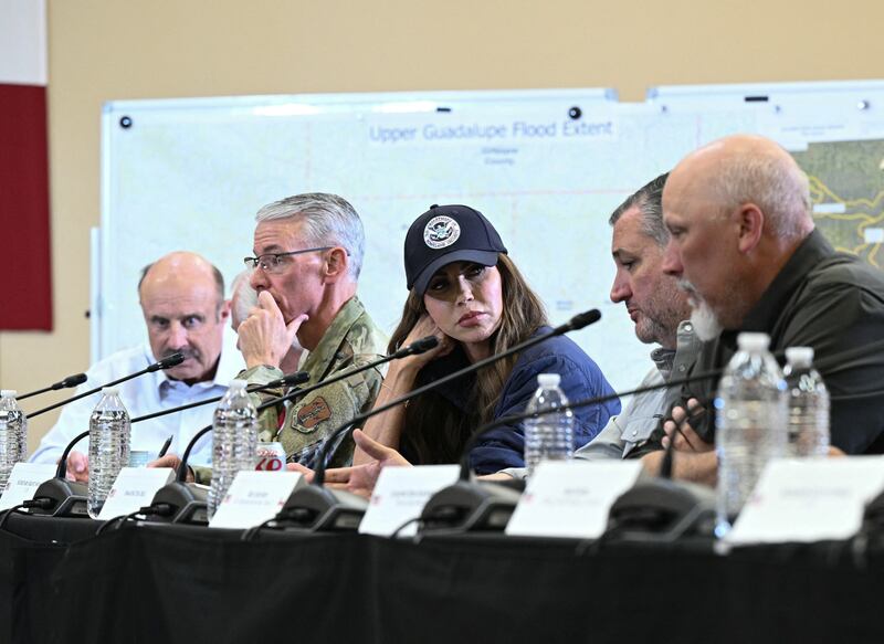 TV personality Phil McGraw (L), known as Dr. Phil, Homeland Security Secretary Kristi Noem (C), US Representative Chip Roy (R), Republican of Texas, listen to US Senator Ted Cruz (2nd R), Republican of Texas, speak during a meeting with local officials and first responders attended by President Donald Trump in Kerrville, Texas, on July 11, 2025, following devastating flooding that ocurred in the area over the July 4 weekend. At least 120 people are dead and more than 170 still missing, following July 4 holiday weekend floods that ravaged the central Texas Hill Country -- including a river bank cluttered with children's summer camp cabins. (Photo by Brendan SMIALOWSKI / AFP) (Photo by BRENDAN SMIALOWSKI/AFP via Getty Images)