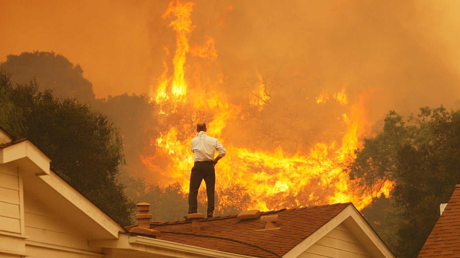 man watching fire flames on his roof carbon emissions global warming ipcc climate change 2 degrees co2 carbon dioxide carbon emissions negative becss bioenergy with carbon capture storage