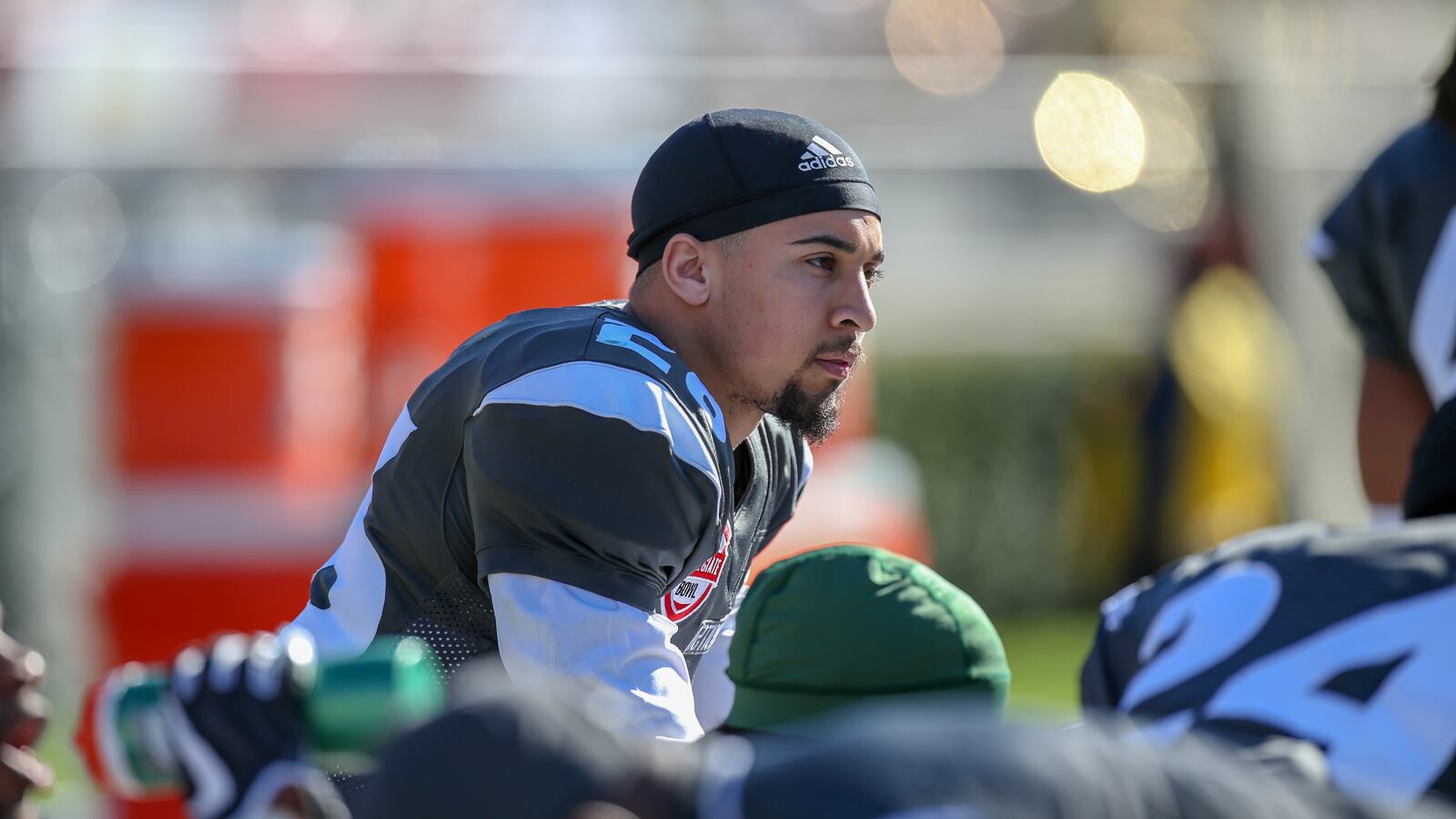 A picture of Blaise Taylor, in uniform, on the sidelines of a college football game.