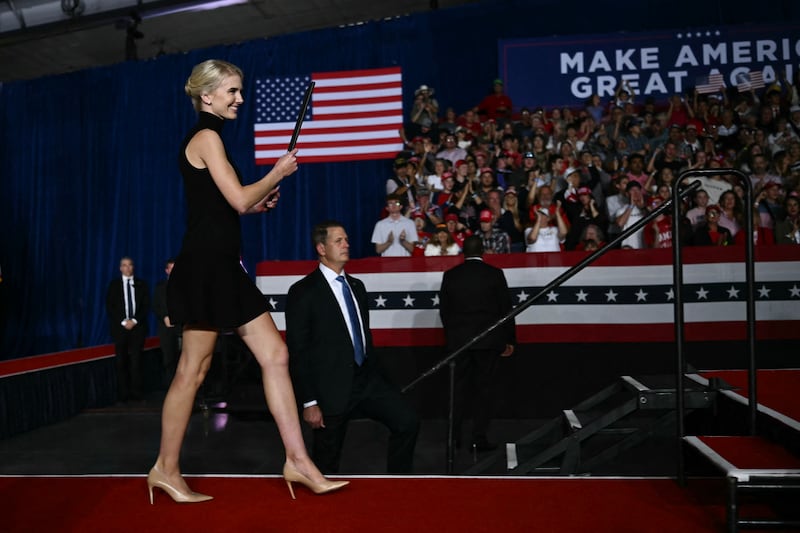 Executive assistant to President Donald Trump, Natalie Harp, brings out an executive order for President Donald Trump to sign during a campaign rally at Pinnacle Bank Expo Center in Grand Island, Nebraska, on October 5, 2026.