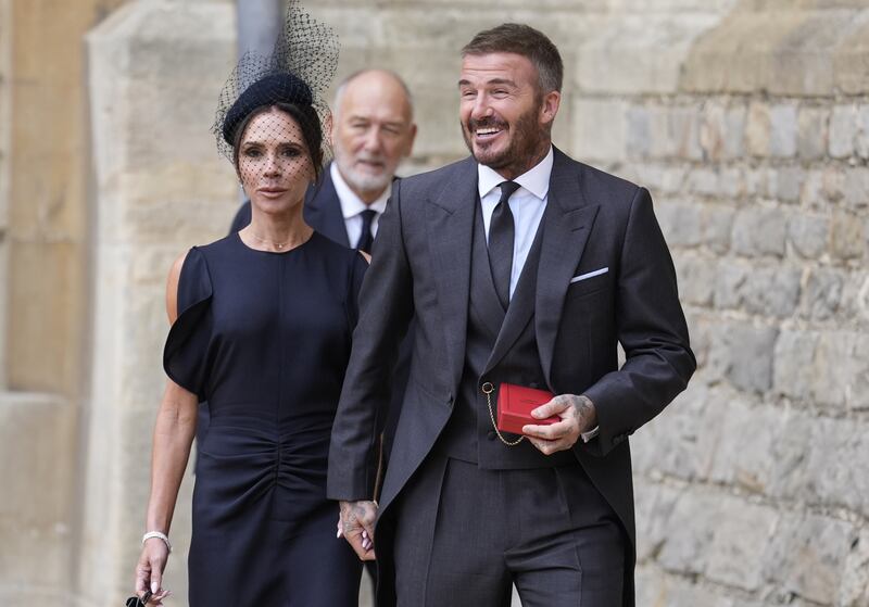 Sir David Beckham walks with his wife Lady Victoria after he was made a Knight Bachelor