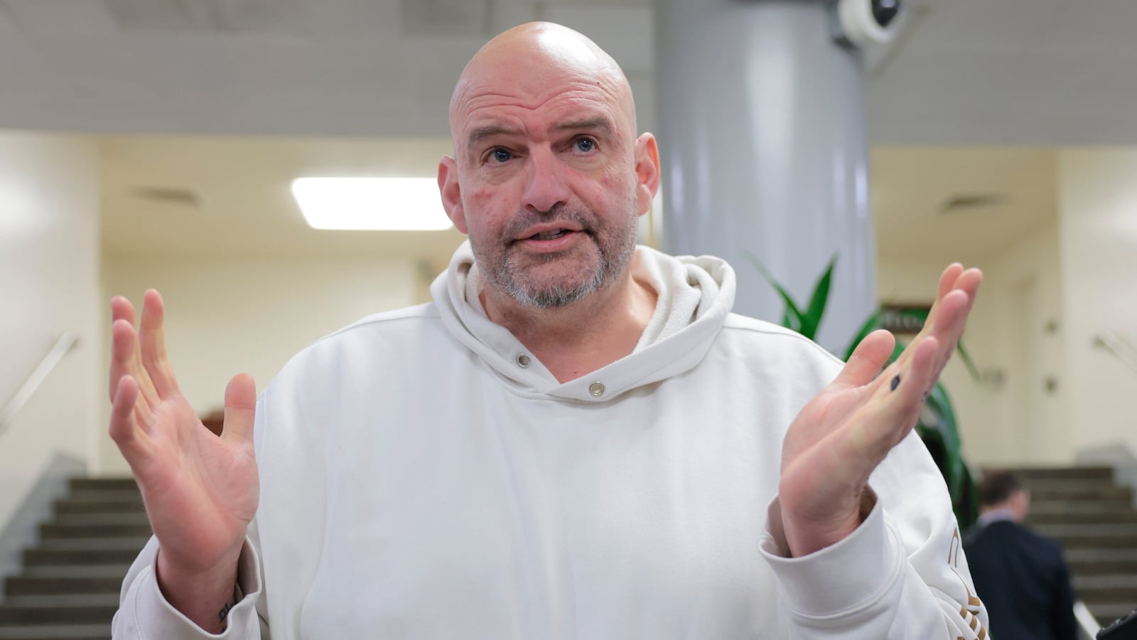 WASHINGTON, DC - FEBRUARY 12: U.S. Sen. John Fetterman (D-PA) speaks to reporters in the Senate Subway during a series of confirmation votes for U.S. President Donald Trump's cabinet nominees at the U.S. Capitol Building on February 12, 2025 in Washington, DC. The Senate voted to confirm Tulsi Gabbard as Director of National Intelligence and completed a procedural vote for the confirmation of Robert F. Kennedy Jr. as Secretary of Health and Human Services. (Photo by Anna Moneymaker/Getty Images)