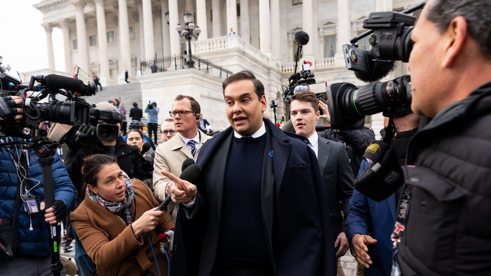 Rep. George Santos wades through the media scrum to his car after the House voted to expel him from Congress in the U.S. Capitol.