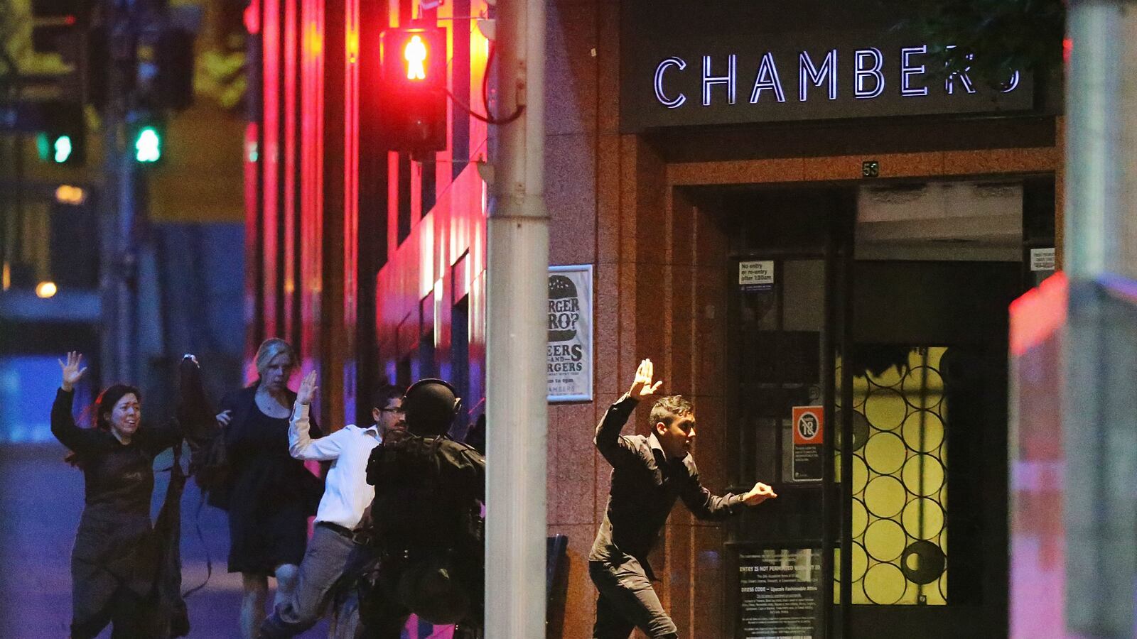 articles/2014/12/14/dozens-held-in-hostage-crisis-in-sydney-amid-fears-of-islamic-terrorism/141215-hostages-run-cheat_dxwqtp